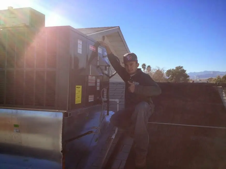 HVAC technician performing HVAC Inspection on a rooftop unit in District Heights